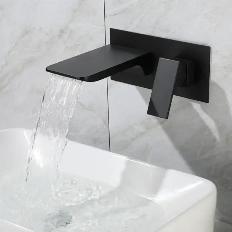 Black matte solid brass basin faucet wall-mounted with sleek modern design for bathroom with brushed gold accents