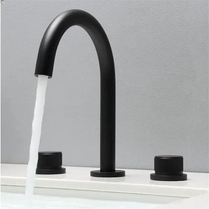 Modern matte black basin faucets with curved spout and brushed gold basin handles for bathroom sink