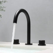 Modern matte black basin faucet with curved spout and two cylindrical handles for brushed gold basin bathroom sink