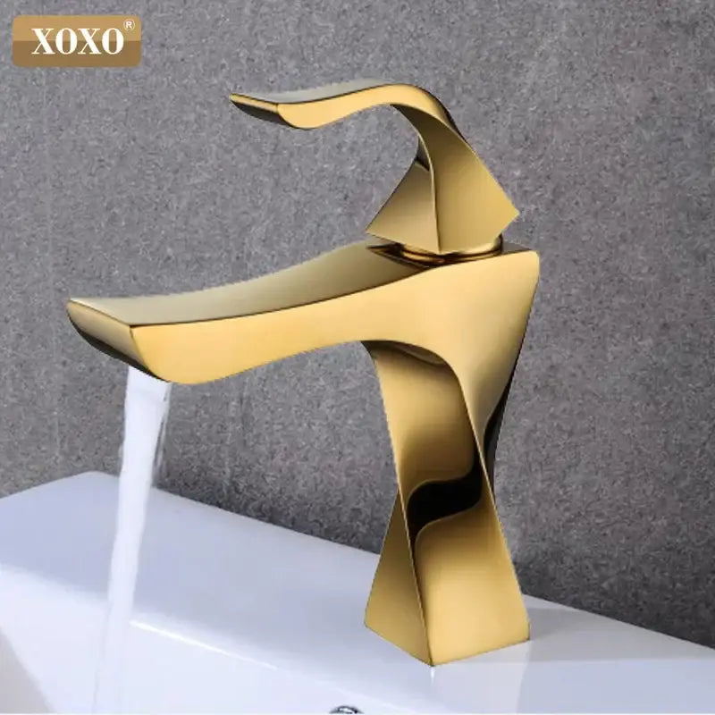 Gold-colored modern basin faucet with sleek sculptural design and polished finish from decorbites contemporary brass collection