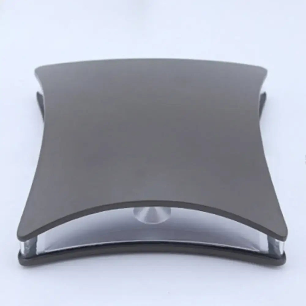 Modern matte black curved rectangular desk lamp with sleek metallic base and transparent glass accent for bedroom use