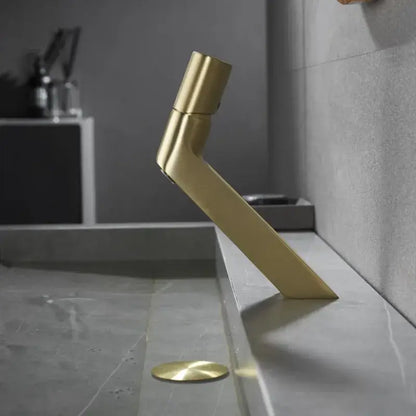 Modern gold-toned decorbites basin faucet with sleek angular design and minimalist aesthetic for bathroom sink use