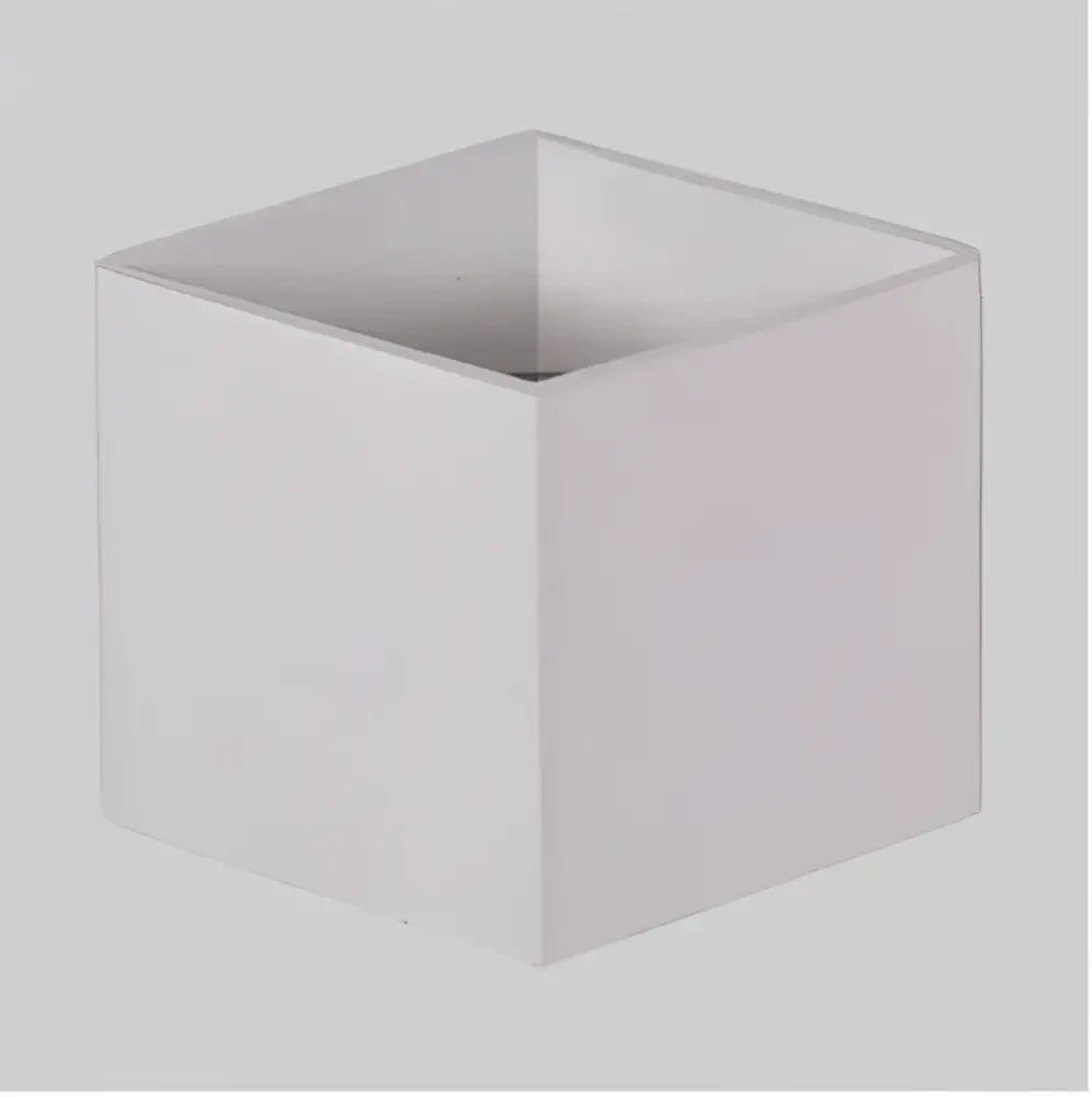 White square ceramic planter with smooth matte finish and geometric edges paired with modern matte black dual-head wall light decorbites wall lamp