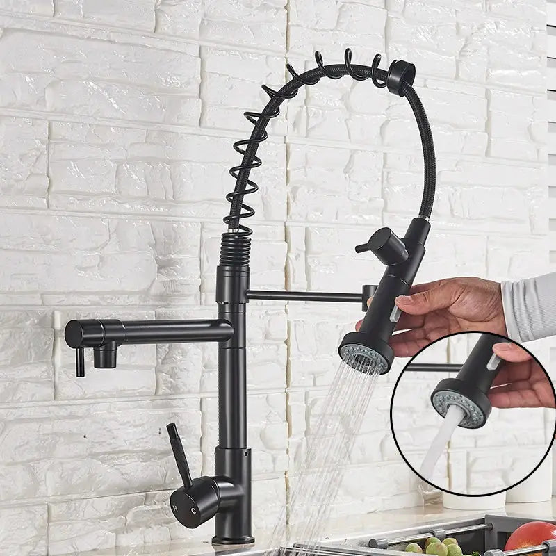 Modern matte black dual spout kitchen sink faucet with spring hose features a black matte finish and flexible coiled hose decorbites dual spout kitchen design