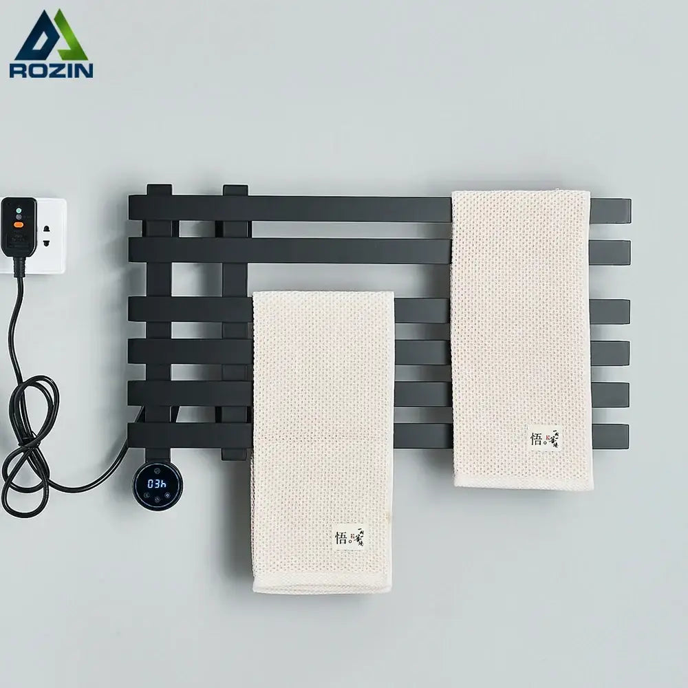 Modern matte black electric towel warmer in black metal with digital display and power cord for bathroom use