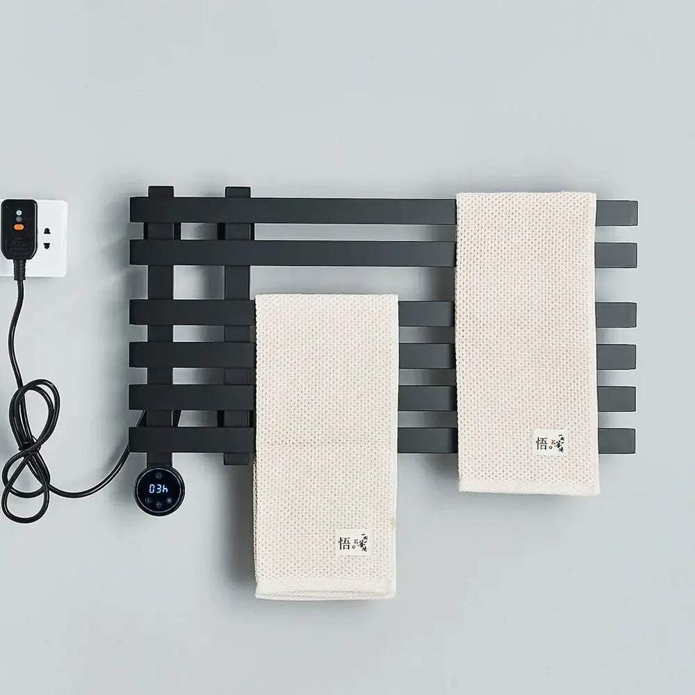 Modern matte black electric towel warmer with digital display and two off-white textured towels hanging on it