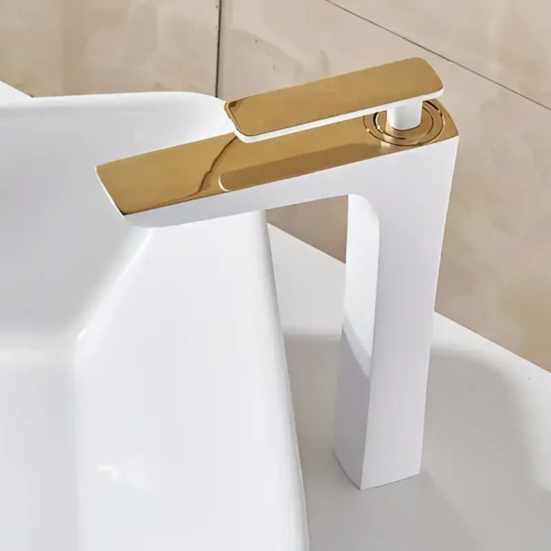 Modern matte black and gold decorbites basin faucet with gold-toned polished metallic finish and sleek angular design