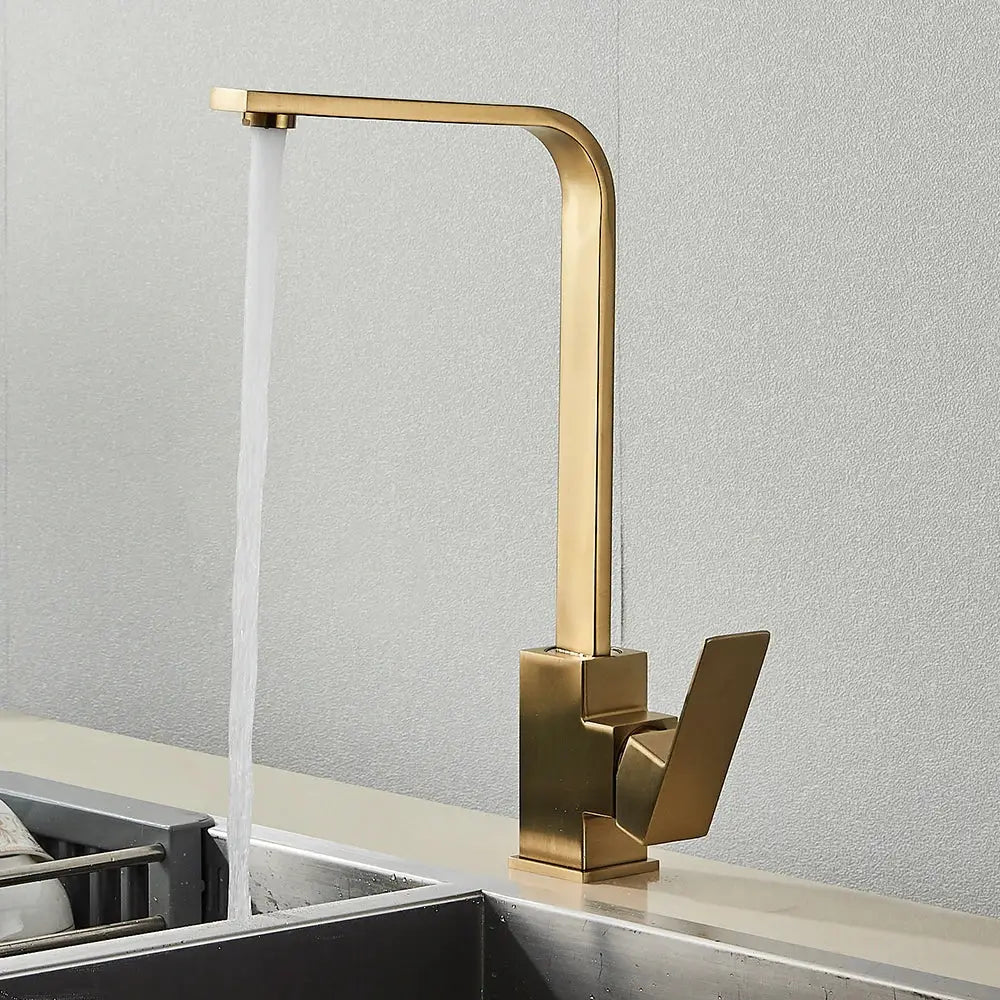 Modern gold-toned kitchen faucet with sleek angular design and brushed metal finish matching decorbites brushed nickel style