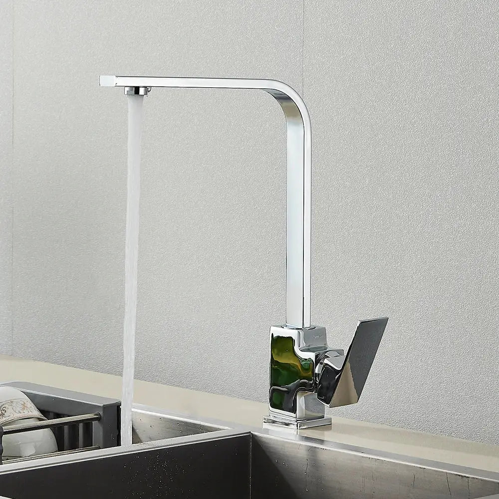 Modern chrome-finished kitchen faucet with angular design and green accent paired with decorbites brushed nickel tap