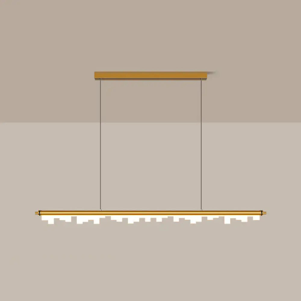 Modern gold-toned pendant light with acrylic shade and warm white LED illuminated jagged cityscape lower edge design