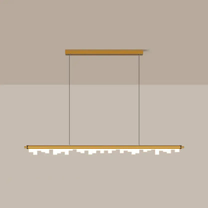 Modern gold-toned pendant light with acrylic shade and warm white LED illuminated jagged cityscape lower edge design
