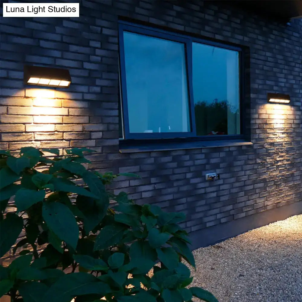 Modern matte black led outdoor wall sconce 110v-120v illuminates brick exterior with warm-toned bulb included light