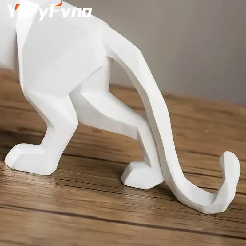 White geometric cat figurine with angular faceted design and smooth surface in decorbites leopard geometric resin statue style