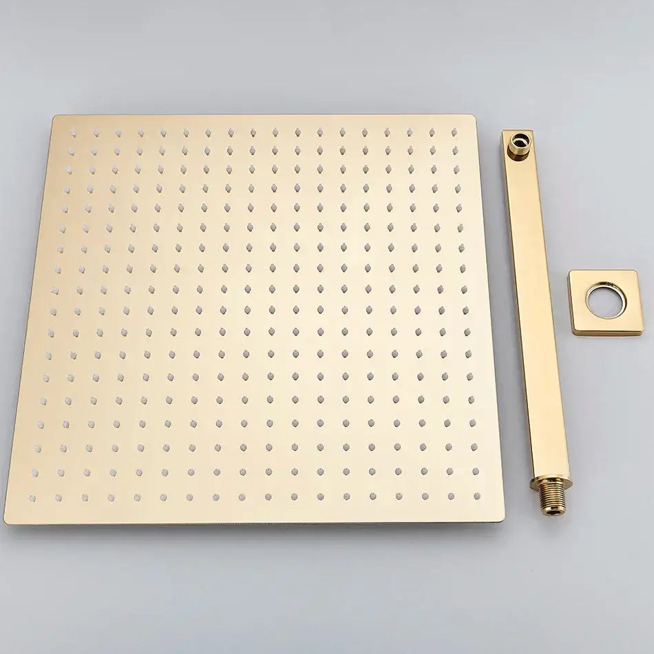 Gold-toned square luxury rain shower head with matching brass shower arm and evenly spaced perforations for bathroom use