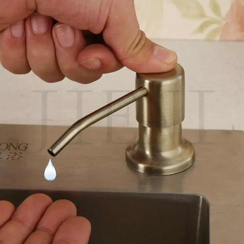 Brass-finished soap dispenser with sleek cylindrical body and curved spout for liquid soap by decorbites grey rose