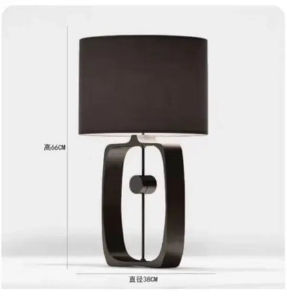 Modern matte black metal table lamp with fabric shade and open rectangular base for living room by decorbites designer
