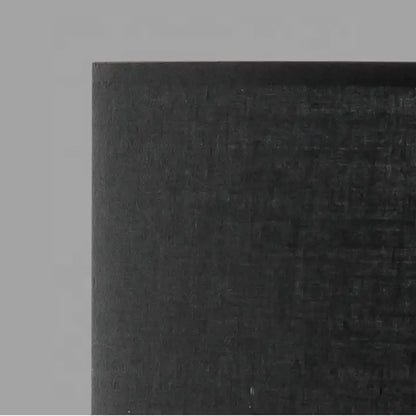 Black carbon fiber panel with textured woven surface on modern matte black metal table lamp for living room decorbites designer