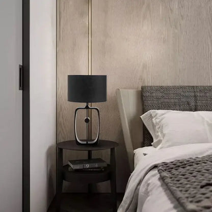 Modern matte black metal table lamp with fabric shade and sleek metallic base for living room decorbites designer table lamp