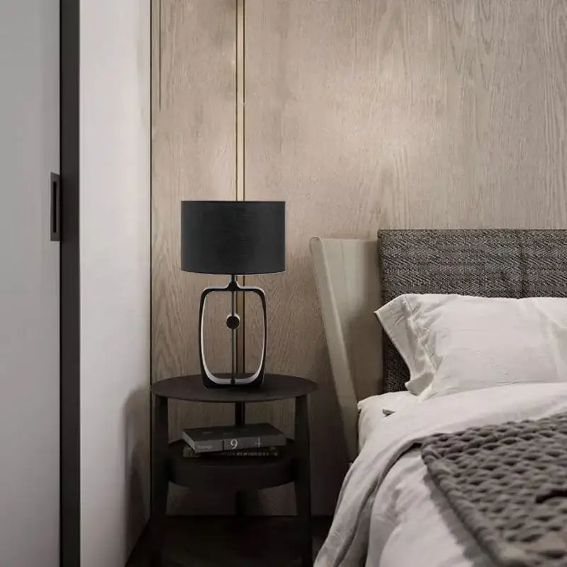 Modern matte black metal table lamp with fabric shade and sleek metallic base for living room decorbites designer table lamp