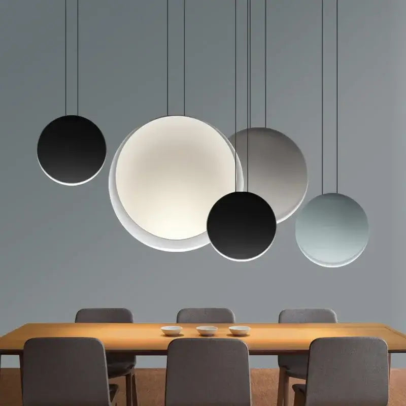 Modern matte black and muted green crescent moon chandelier with minimalist circular pendant lights for dining room decorbites crescent moon