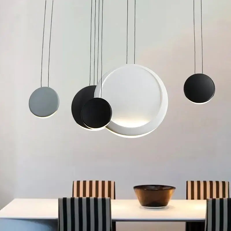 Modern matte black and muted green crescent moon chandelier with sleek black and white circular pendant lights by decorbites crescent moon