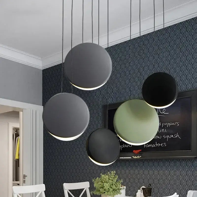 Modern matte black and muted green crescent moon chandelier with minimalist pendant lights by decorbites for dining room decor