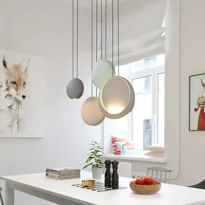 Modern matte black and muted green crescent moon chandelier with spherical gray and cream pendant lights by decorbites crescent moon