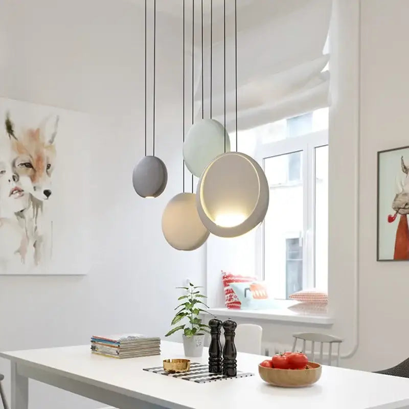 Modern matte black and muted green crescent moon chandelier with spherical gray and cream pendant lights by decorbites crescent moon