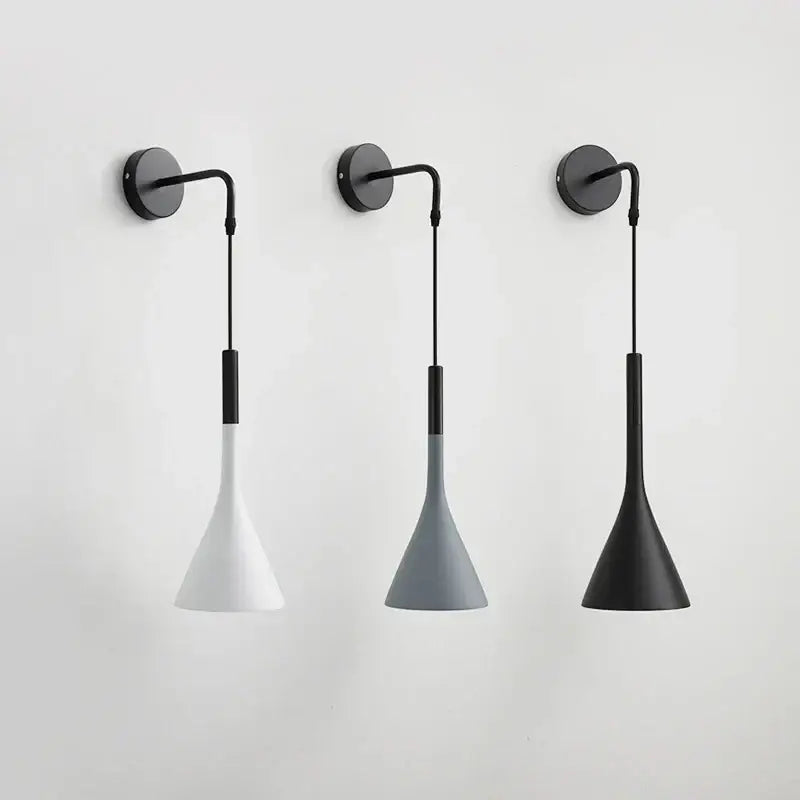 Three minimalist modern matte black nordic led wall light sconces with black bases and conical white gray and matte black shades