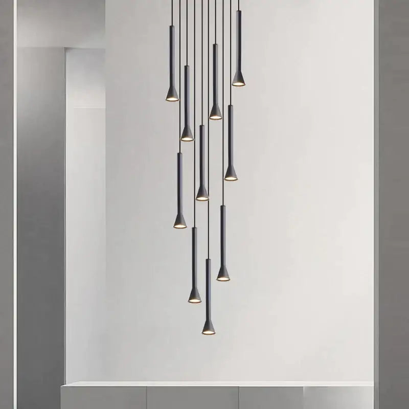Modern matte black nordic pendant lamp with slender cylindrical shades and warm lighting for living room staircase