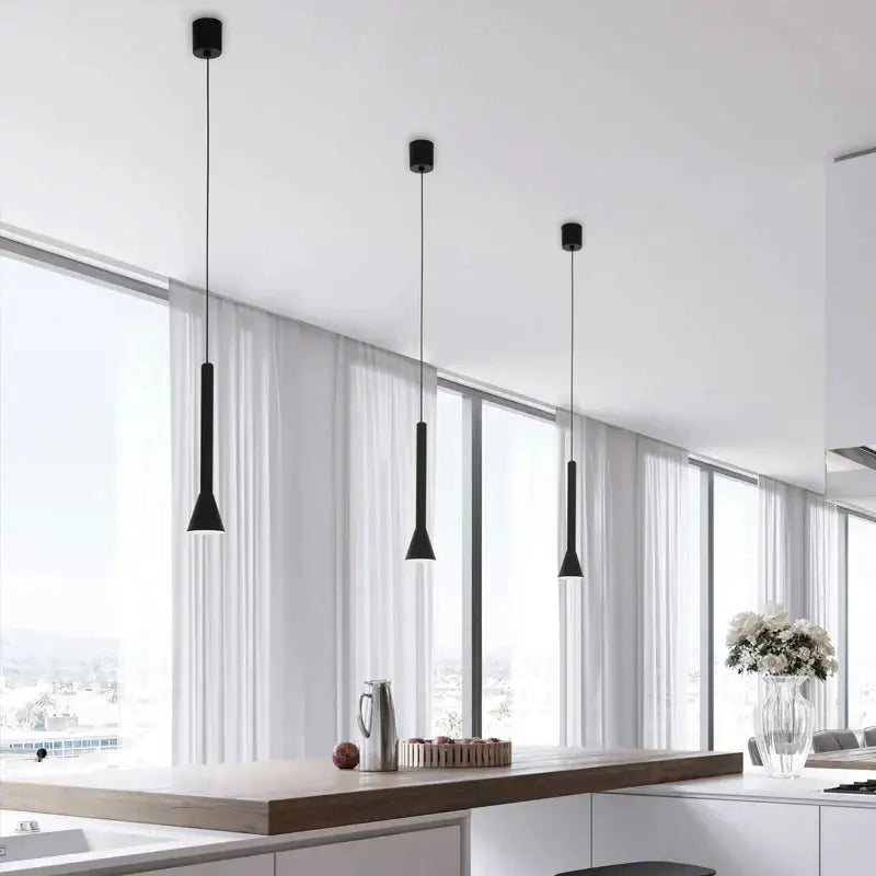 Three sleek black matte nordic pendant lamps with minimalist cylindrical design for living room or staircase lighting