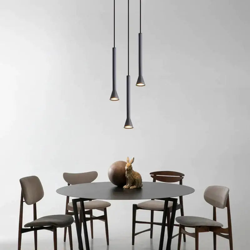 Modern matte black nordic pendant lamp with sleek cylindrical shapes and warm downward illumination for living room