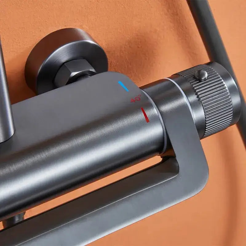 Matte black brushed metal mixing faucet with blue and red temperature indicators in modern shower faucet set