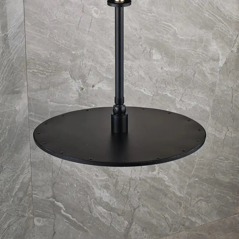 Modern matte black round brass rain shower head with black metal industrial-style pendant light and circular base
