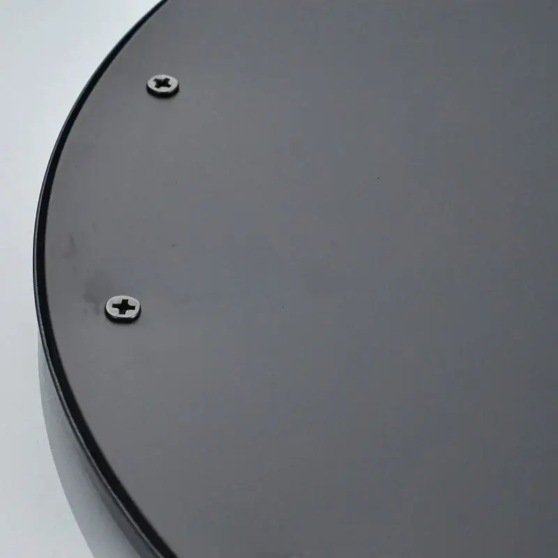 Black round brass rain shower head bathroom fixture showing the back side with two silver screws on metal plate