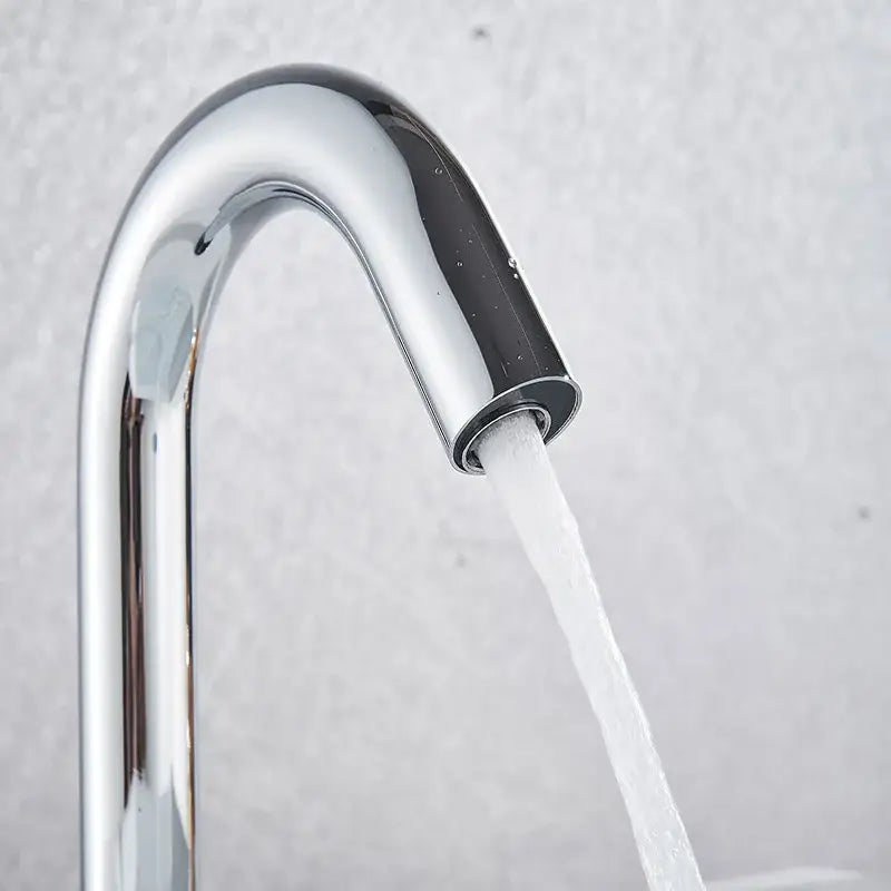 Modern matte black sensor faucet with chrome finish, sleek curved spout, and flowing water stream for bathroom use