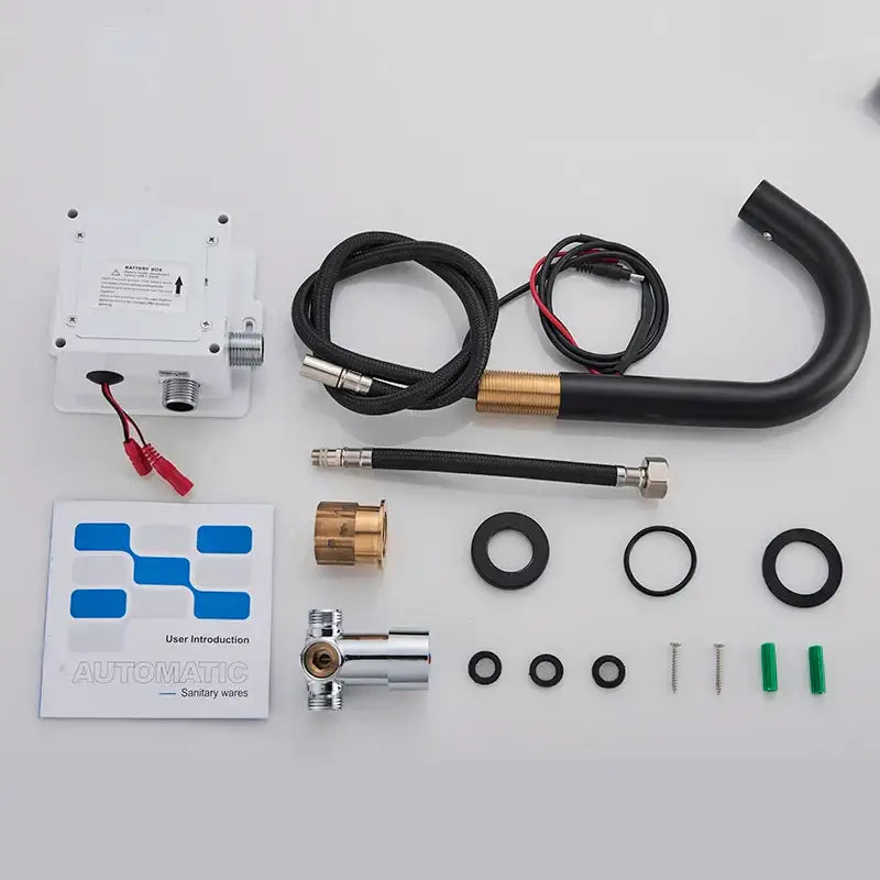 White plastic battery box with metal connectors and red wires on the back of a decorbites black sensor faucet