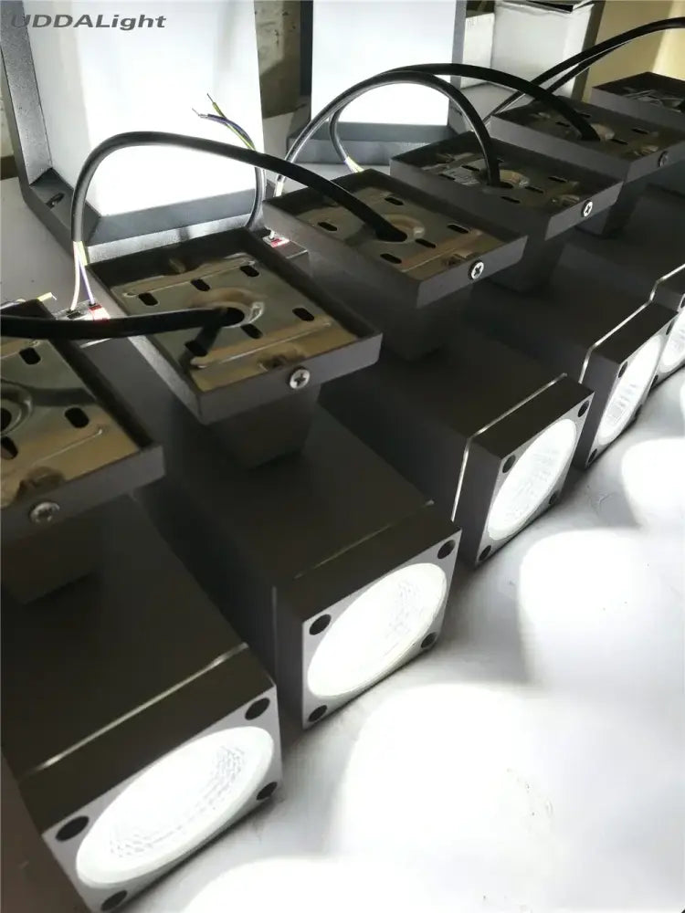 Modern matte black and silver outdoor wall lamp with rectangular led sconces and circular white light panels