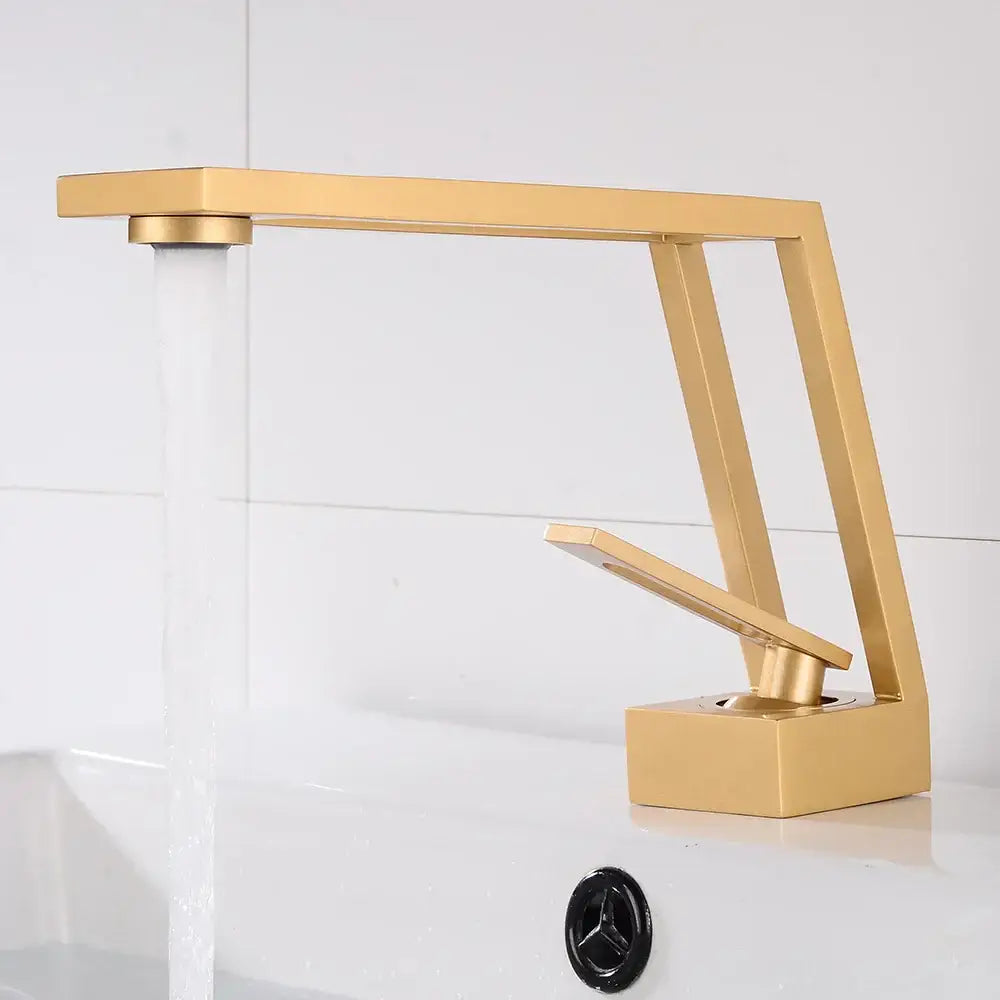 Modern gold-toned single handle basin faucet with sleek angular design and rectangular spout for bathroom decorbites black single use