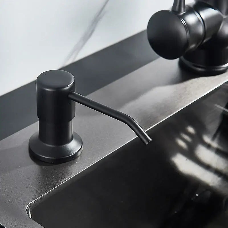 Modern matte black soap dispenser with stainless steel head and curved spout for kitchen use