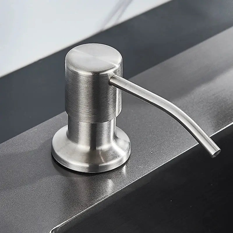Modern matte black soap dispenser with stainless steel head and sleek brushed finish curved spout for kitchen use