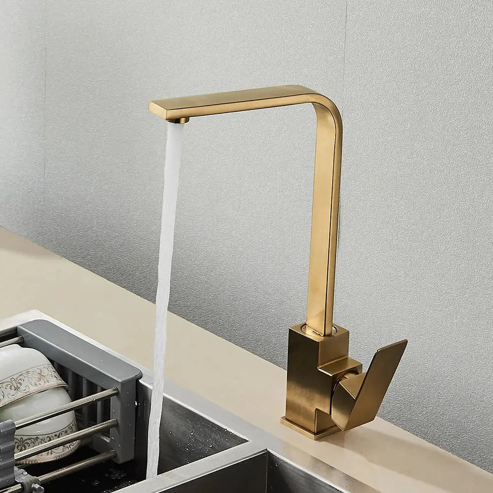 Modern gold-toned kitchen faucet with sleek angular design and brushed metal finish for decorbites black square kitchen decor