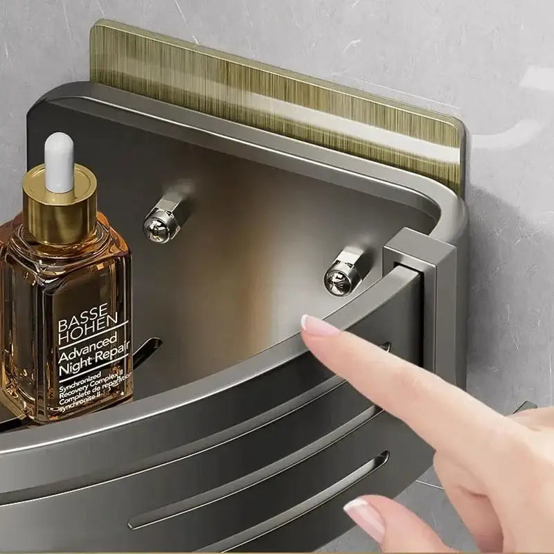 Modern matte black stainless steel corner shelf organizer with gold-accented adhesive strip and silver-toned knobs