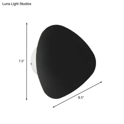 Modern matte black triangle wall lamp with a matte finish and white mounting base for corridor lighting