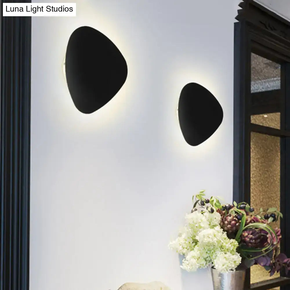 Modern matte black triangle wall lamp with sleek matte finish designed for corridor lighting and decoration