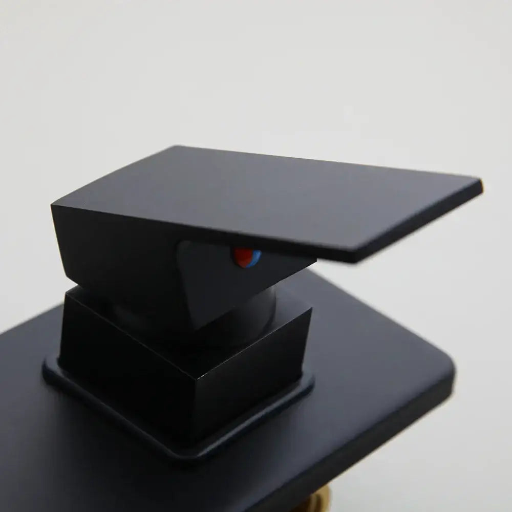 Modern matte black wall mounted basin faucet with square black matte finish and red and blue indicator on handle