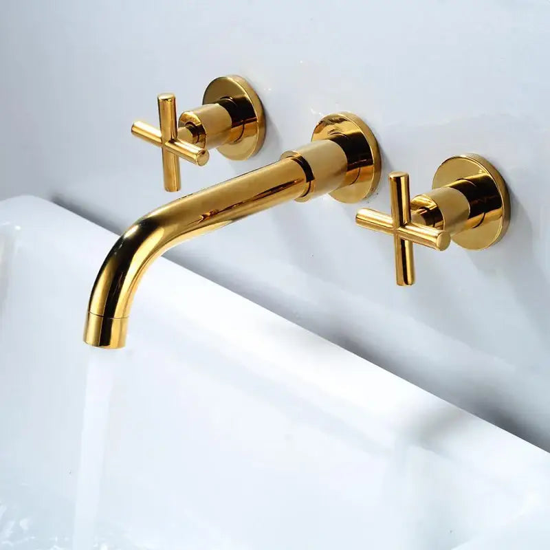 Gold-colored wall-mounted dual handle bathroom sink mixer tap with cross-shaped handles and modern design