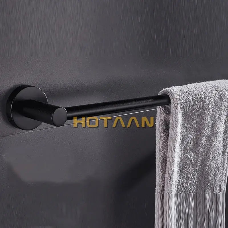 Modern matte black wall mounted towel bar with wood accents featuring a sleek black matte metal towel rack design