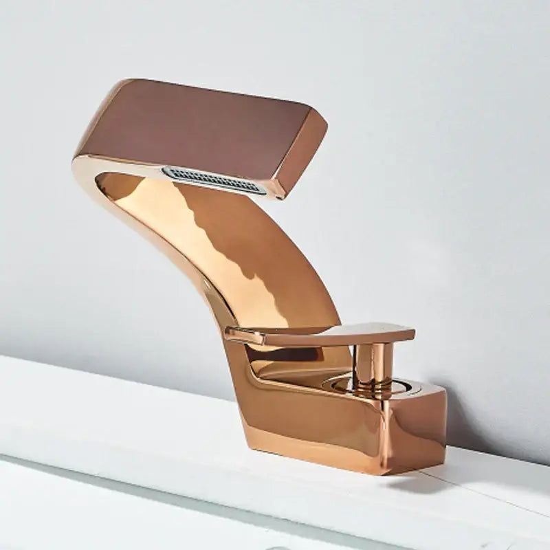 Modern rose gold basin faucet with sleek angular design and rectangular spout for decorbites black waterfall bathroom use