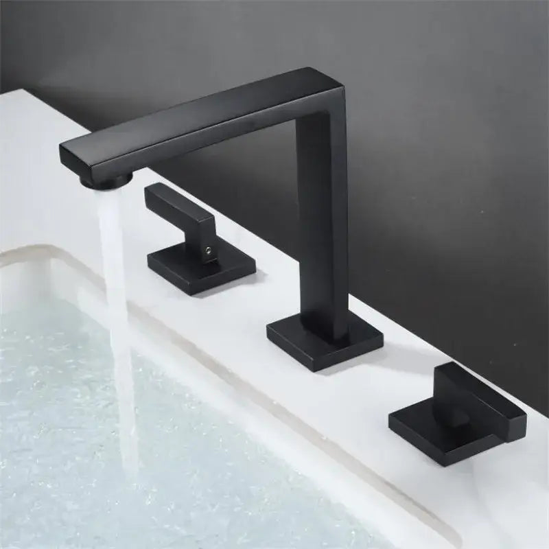 Modern matte black waterfall basin faucet with three square handles and a sleek rectangular spout for bathroom decorbites brushed gold style
